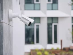 AXIS P1455-LE from AXIS COMMUNICATIONS - IP Camera mounted on a facade in an outdoor environment