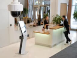 AXIS M5526-E from AXIS COMMUNICATIONS - PTZ Camera hanging from roof in a hotel lobby